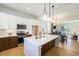 Spacious open floor plan with bright kitchen and view to dining and living areas at 888 S Valentia St # 104, Denver, CO 80247