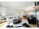 Spacious living room with hardwood floors and a white rug, featuring an open layout to the kitchen at 888 S Valentia St # 104, Denver, CO 80247