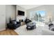 Cozy living room with a fireplace, large glass doors to a patio, and comfortable seating on a plush rug at 888 S Valentia St # 104, Denver, CO 80247
