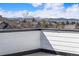 Mountain view from a roof deck showing the distant snow capped peaks at 888 S Valentia St # 104, Denver, CO 80247