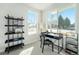 Bright office features a sleek black desk, stylish shelving, and plenty of natural light from large windows at 888 S Valentia St # 104, Denver, CO 80247