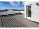 Spacious roof deck with wood flooring and panoramic views of the neighborhood and distant mountains at 888 S Valentia St # 104, Denver, CO 80247