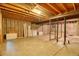 Unfinished basement with exposed beams, concrete floor, and potential for customization at 10320 E Jewell Ave # 63, Aurora, CO 80247