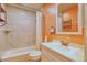 Updated bathroom with custom vanity, a tub and shower combo with tiled walls at 10320 E Jewell Ave # 63, Aurora, CO 80247