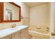 Bathroom with updated vanity, mirror, lighting, tub and shower at 10320 E Jewell Ave # 63, Aurora, CO 80247