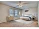 A well-lit bedroom offers a comfortable bed, dresser and modern ceiling fan at 10320 E Jewell Ave # 63, Aurora, CO 80247