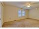 A bright and airy bedroom with plush carpeting and natural light from two windows at 10320 E Jewell Ave # 63, Aurora, CO 80247