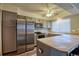 Well-lit kitchen with gray cabinets, stainless steel appliances, and a breakfast bar at 10320 E Jewell Ave # 63, Aurora, CO 80247