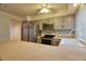 Spacious kitchen with gray cabinetry, stainless appliances, and ample counter space at 10320 E Jewell Ave # 63, Aurora, CO 80247