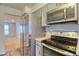 Updated kitchen with stainless steel appliances and view into the living space at 10320 E Jewell Ave # 63, Aurora, CO 80247
