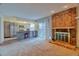 Open-concept living room with brick fireplace and view of the kitchen at 10320 E Jewell Ave # 63, Aurora, CO 80247