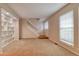 Bright living room featuring carpet floors, and a staircase leading to the upper level at 10320 E Jewell Ave # 63, Aurora, CO 80247