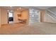 Living room with built-in shelving and desk, tan walls and neutral carpet at 10320 E Jewell Ave # 63, Aurora, CO 80247