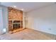 Spacious living room featuring a decorative brick fireplace and neutral carpeting at 10320 E Jewell Ave # 63, Aurora, CO 80247