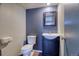 Updated powder room with vanity and framed mirror on a dark blue accent wall at 10320 E Jewell Ave # 63, Aurora, CO 80247