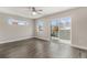 Bedroom with hardwood floors, sliding door to balcony, and ceiling fan at 1449 Ivy St, Denver, CO 80220