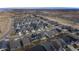 This is an aerial view of a gray roofed house within a neighborhood in a hilly area at 8791 Culebra Ct, Arvada, CO 80007