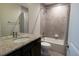 Bright bathroom has modern vanity with granite counter and tiled shower over tub at 8791 Culebra Ct, Arvada, CO 80007