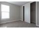 Bright bedroom features neutral walls, plush carpet, and a closet with a sliding door at 8791 Culebra Ct, Arvada, CO 80007