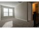 This bedroom has neutral walls, plush carpeting, bright windows and leads to the bathroom at 8791 Culebra Ct, Arvada, CO 80007