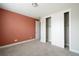 Cozy bedroom with plush carpet, closet, and an accent wall at 8791 Culebra Ct, Arvada, CO 80007