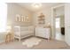 Charming Bedroom with a white crib, dresser, and whimsical wall art at 8791 Culebra Ct, Arvada, CO 80007
