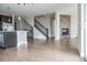 Open concept living room adjacent to the kitchen with a fireplace and staircase at 8791 Culebra Ct, Arvada, CO 80007