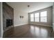 Spacious living room with fireplace, tile accent wall and large windows at 8791 Culebra Ct, Arvada, CO 80007