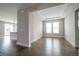 Bright, open living room with hardwood floors and ample natural light from large windows at 8791 Culebra Ct, Arvada, CO 80007