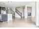 Open concept living room adjacent to the kitchen with a fireplace and staircase at 8791 Culebra Ct, Arvada, CO 80007