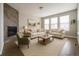 Cozy living room with a fireplace, comfortable seating, and natural light at 8791 Culebra Ct, Arvada, CO 80007
