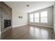 Cozy living room with a modern fireplace and three bright, light-filled windows at 8791 Culebra Ct, Arvada, CO 80007