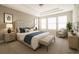 Serene main bedroom featuring a tufted headboard and an abundance of natural light at 8791 Culebra Ct, Arvada, CO 80007