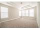 Bright main bedroom featuring large windows, neutral walls, and tray ceiling at 8791 Culebra Ct, Arvada, CO 80007