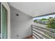 Apartment balcony with wooden floors and railings, overlooking lush greenery at 7665 E Eastman Ave # 301A, Denver, CO 80231