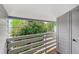 Apartment balcony featuring wooden floors and railings, with views of trees at 7665 E Eastman Ave # 301A, Denver, CO 80231