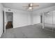 Spacious carpeted bedroom with ceiling fan and mirrored closet doors at 7665 E Eastman Ave # 301A, Denver, CO 80231