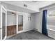 Bedroom featuring hardwood floors and a closet, next to living room with ceiling fan at 7665 E Eastman Ave # 301A, Denver, CO 80231