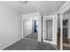 Bedroom featuring sliding door closet, and an adjacent bedroom and doorway at 7665 E Eastman Ave # 301A, Denver, CO 80231