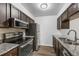 Kitchen featuring granite countertops, backsplash, stainless steel appliances, and hardwood floors at 7665 E Eastman Ave # 301A, Denver, CO 80231