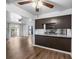Open kitchen with granite countertops, stainless steel appliances, and hardwood floors at 7665 E Eastman Ave # 301A, Denver, CO 80231