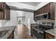 Kitchen featuring granite countertops, stainless steel appliances, and hardwood floors at 7665 E Eastman Ave # 301A, Denver, CO 80231