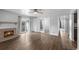Spacious living room featuring a fireplace, ceiling fan, balcony, and hardwood floors at 7665 E Eastman Ave # 301A, Denver, CO 80231