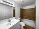 Bathroom featuring tile floors, a shower-tub combo, and a vanity with a mirror at 11813 Grant St, Northglenn, CO 80233