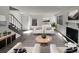 Bright living room with fireplace, light gray wood floors, and striped rug at 11813 Grant St, Northglenn, CO 80233