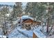 Overhead view of a beautiful home surrounded by lush trees and snowy landscape at 26288 S End Rd, Kittredge, CO 80457