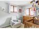 Bedroom with natural light, windows with light blue curtains, and a crib at 26288 S End Rd, Kittredge, CO 80457