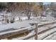 Scenic creek with a wooden fence in the foreground, bare trees and snow-covered banks in the background at 26288 S End Rd, Kittredge, CO 80457