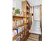 Hallway with built-in bookshelves and carpeted stairs, offering a cozy and functional space at 26288 S End Rd, Kittredge, CO 80457