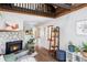 Comfortable living room with a stone fireplace, wooden beams, and inviting natural light at 26288 S End Rd, Kittredge, CO 80457